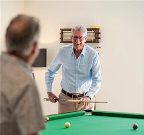 Older-Man-Playing-Pool-In-Retirement-Village